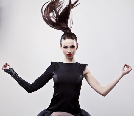 Gorgeous young woman sitting on a chair の写真素材