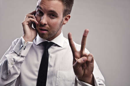 Young handsome businessman talking on mobile phone  