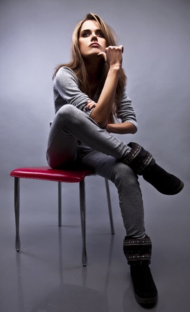 Gorgeous young woman sitting on a chair の写真素材