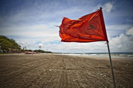 Warning red flag on a strong wind  