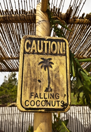 Old funny wooden caution sign on the beach  の写真素材