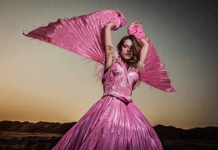 Attractive romantic woman on beautiful pink dress pose outdoor  の写真素材