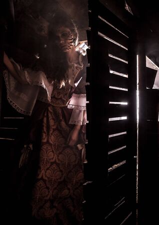 Fine art image of a young fashion lady in a dark mystic location  の写真素材