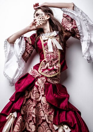 Fine art photo of a young lady in medieval dress with thorns of roses on her face  の写真素材