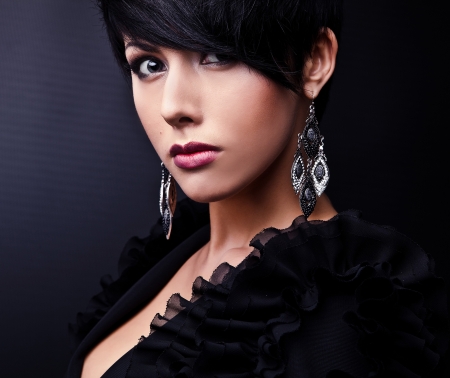 Beautiful woman on black classical dress pose in studio  の写真素材