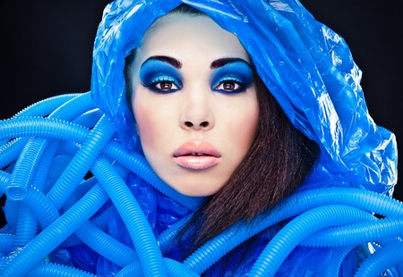 Futuristic beautiful young female face with blue fashion make-up  の写真素材