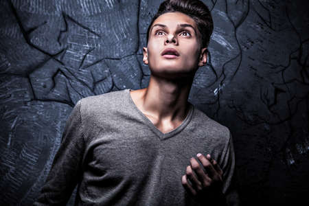 Elegant young handsome man on grunge background  Studio fashion portrait  の写真素材