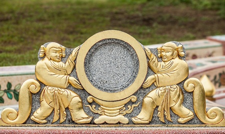 Traditional asian image cut from stone on a wall のeditorial素材