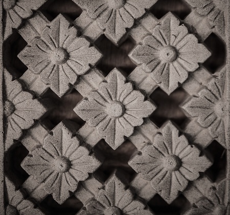Traditional asian image cut from stone on a wall 