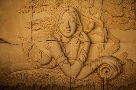 Traditional asian image cut from stone on a wall のeditorial素材