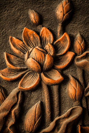 Traditional asian image cut from stone on a wall の写真素材