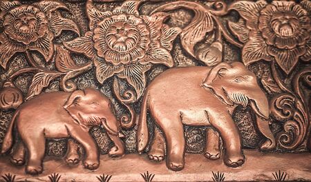 Traditional asian image cut from stone on a wall のeditorial素材