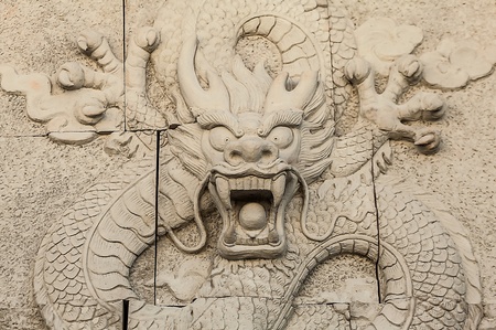 Traditional asian image cut from stone on a wall の写真素材