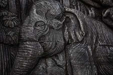 Traditional asian image cut from stone on a wall のeditorial素材