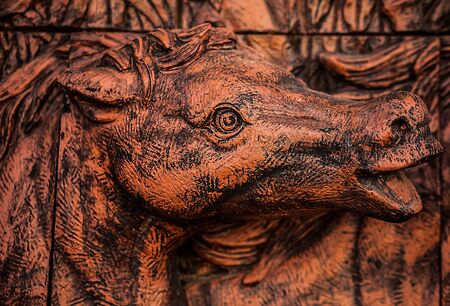 Traditional asian image cut from stone on a wall のeditorial素材