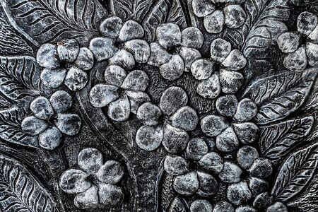 Traditional asian image cut from stone on a wall の写真素材