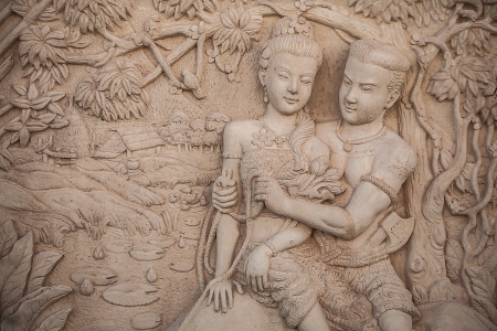 Traditional asian image cut from stone on a wall のeditorial素材