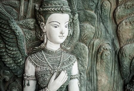 Traditional asian image cut from stone on a wall のeditorial素材