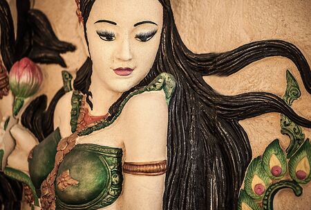 Traditional asian image cut from stone on a wall のeditorial素材