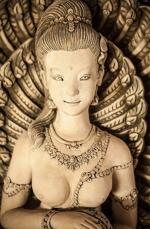 Traditional asian image cut from stone on a wall 