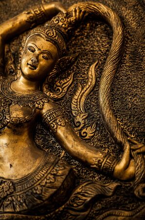 Traditional asian image cut from stone on a wall のeditorial素材