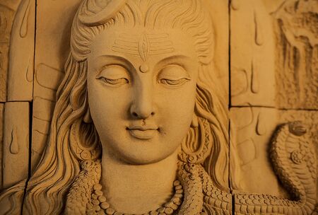 Traditional asian image cut from stone on a wall のeditorial素材