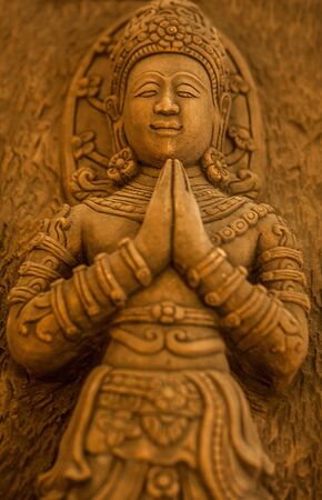 Traditional asian image cut from stone on a wall のeditorial素材