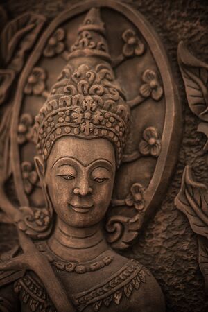 Traditional asian image cut from stone on a wall のeditorial素材