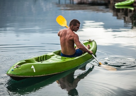Strong young man in kayak on the picturesque lake in Thailand の写真素材