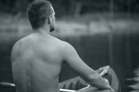 Strong young man in kayak on the picturesque lake in Thailand の写真素材