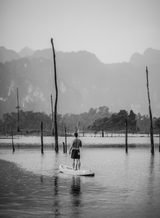 Strong young man in kayak on the picturesque lake in Thailand の写真素材