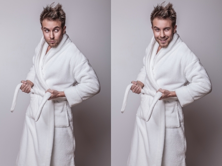 Handsome smiling young man in luxurious bathrobe   の写真素材