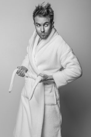 Handsome smiling young man in luxurious bathrobe   の写真素材