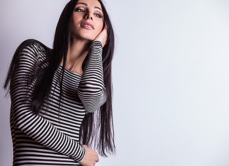 Attractive friendly brunette pose in studio   の写真素材