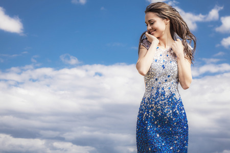 Young sensual   beauty smiling woman in a fashionable dress pose outdoor   の写真素材