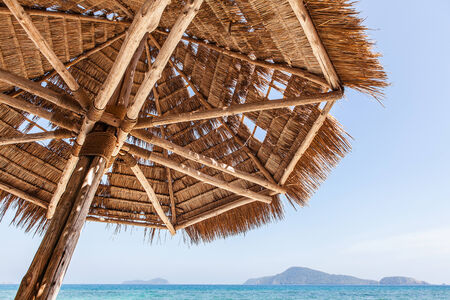 Straw umbrella on beachの写真素材