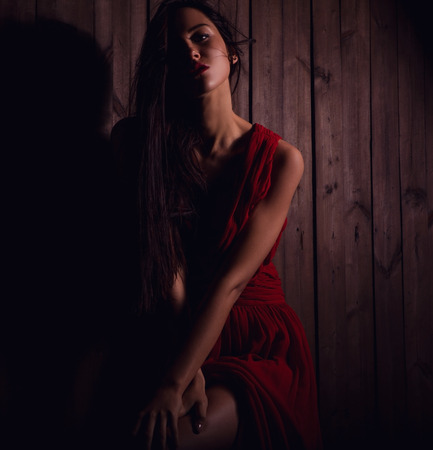 Lady in red pose on wooden .Close-up photo の写真素材
