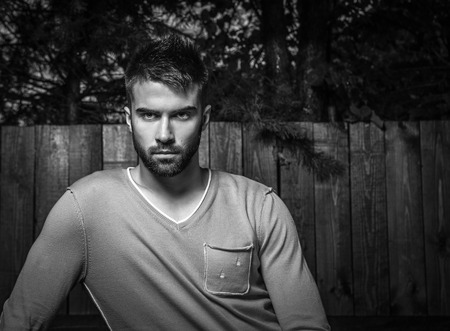 Black-white portrait of young beautiful man, against outdoor の写真素材