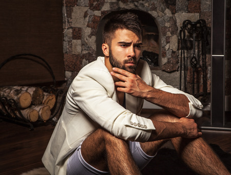 Young attractive bearded men pose in modern room  Close-up photo の写真素材