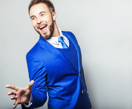 Elegant & friendly young handsome man in costume. Studio fashion portrait.の写真素材