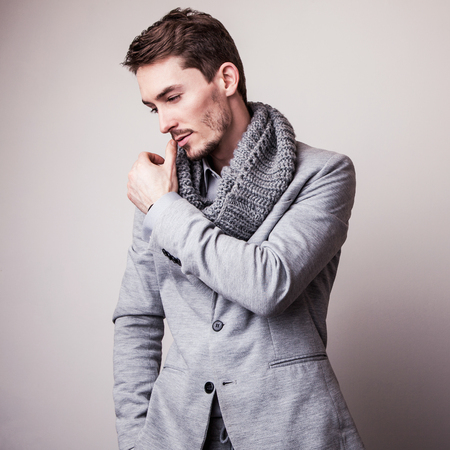Elegant young handsome man in grey costume. Studio fashion portrait.の写真素材