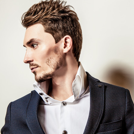 Elegant young handsome man in classic costume. Studio fashion portrait.の写真素材