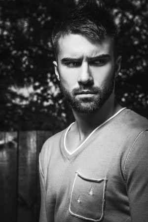 Portrait of young beautiful man against outdoor background.の写真素材