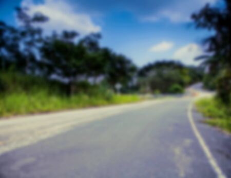 Beautiful blurred tropical view in defocus. Landscape photo with empty road.の写真素材
