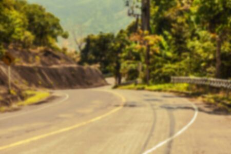 Beautiful blurred tropical view in defocus. Landscape photo with empty road.の写真素材