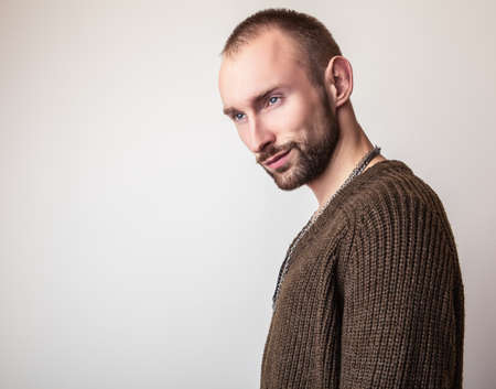 Studio portrait of young handsome man in casual knitted sweater. Closeup photo.の写真素材