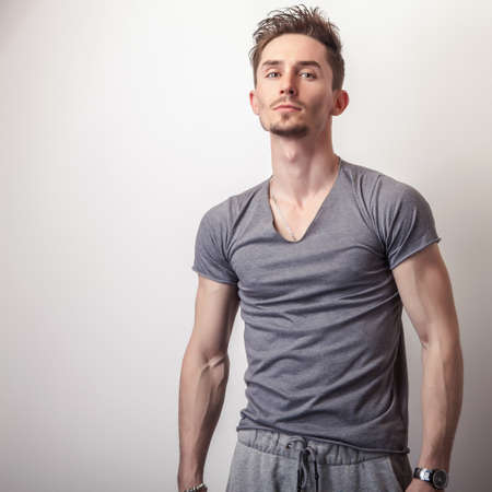 Portrait of young handsome man in grey t-shirt.の写真素材
