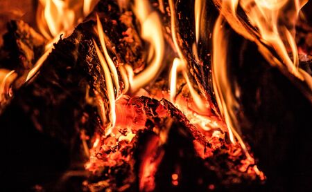 Fireplace with a blazing fire. Photo.