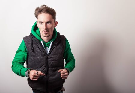 Attractive young man in grey vestの写真素材