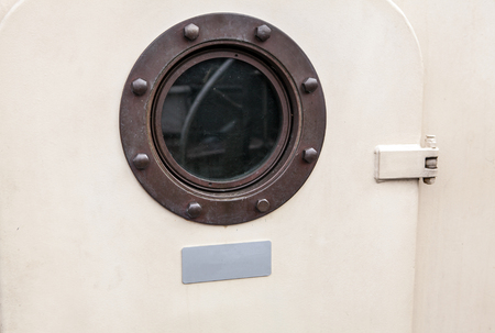 Brass porthole - ferry window frame.の写真素材